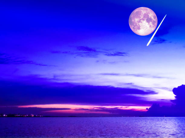 istock buper moon and meteor fall cold sky over sea 856489516