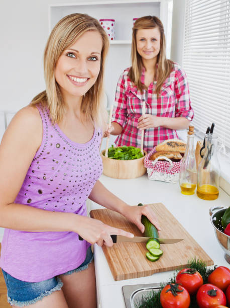 istock Cheerful women cooking together at home 856492672