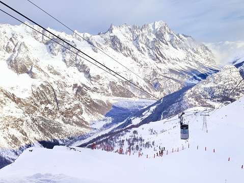 Winter snow mountains ski slopes in Courmayeur, European Alps, ski lift