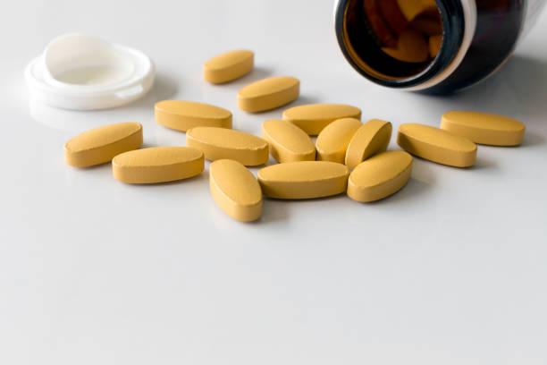 istock closeup vitamin C tablets on white table with soft-focus and over light in the background 856500566