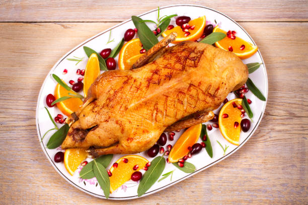 istock Whole duck with oranges, berries, sage and rosemary 856504444