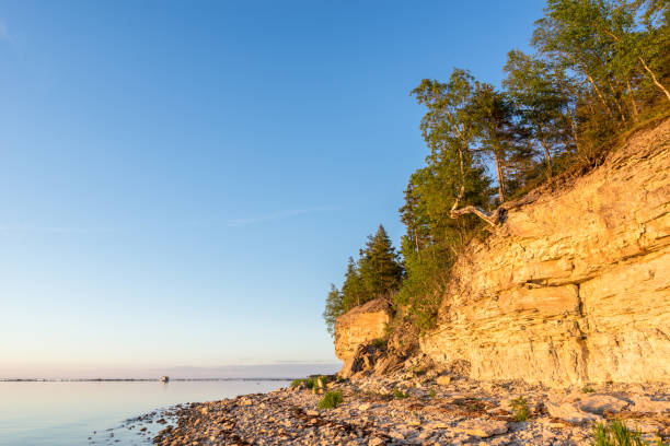 istock Sunset on the beach. Limestone cliff in the sea under blue sky and white clouds. Kesselaid, a small island in Estonia. Nordic countries, Europe 856504882