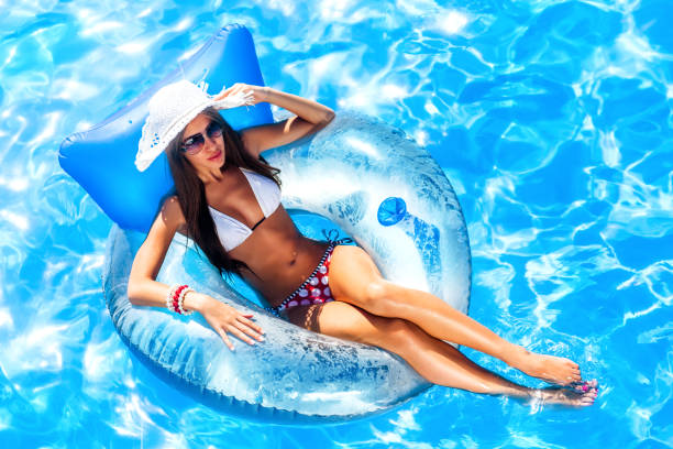 young pretty woman relaxing in swimming pool. - swimming tube inflatable circle imagens e fotografias de stock