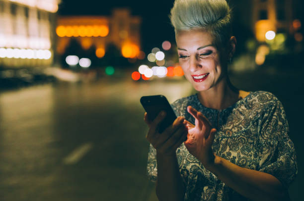 istock Elegant woman texting at night 856525954