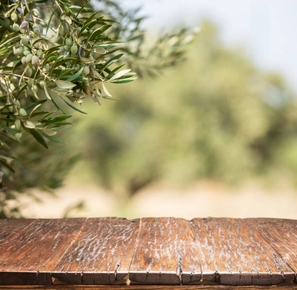 istock Olives with old wooden table. Blur nature background. 856526394