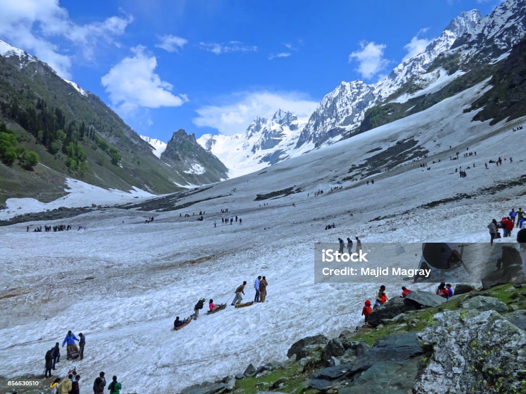 THAJIWAS GLACIER, SONAMARG, KASHMIR, INDIA. Tourists enjoy snow ride at the famed Thajiwas glacier in the picturesque sonamarg, the meadow of gold, located at Srinagar-leh highway. Glacier Stock Photo