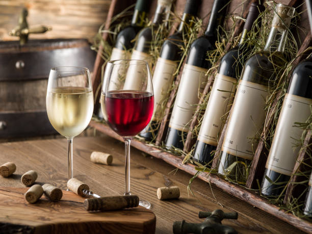 istock Wine bottles on the wooden shelf. 856530584