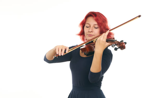 istock Beautiful young redhead woman playing the violin 856530644