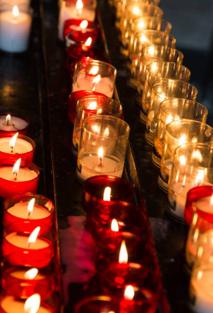 istock Small tea candle burning in church 856538082