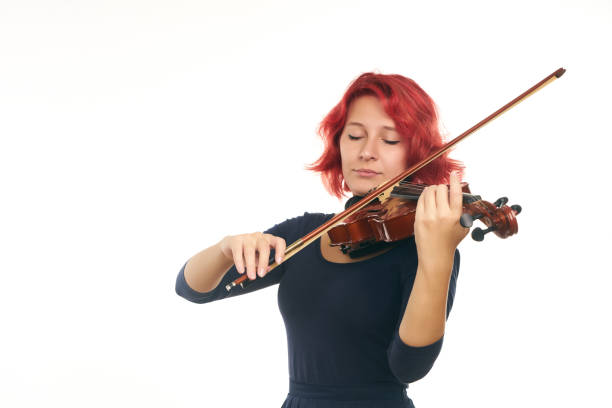 istock Beautiful young redhead woman playing the violin 856538110