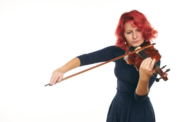 istock Musician beautiful young woman playing violin 856540830