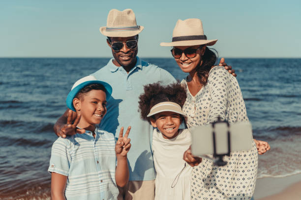 istock family taking selfie at seaside 856544046