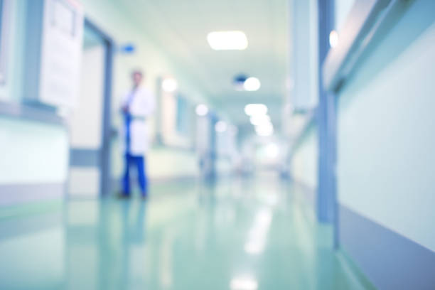 Doctor in hospital corridor, unfocused background Doctor in hospital corridor, unfocused background. emergency medicine stock pictures, royalty-free photos & images