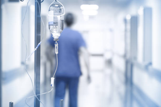 Drip on the background of doctor walking down the hall