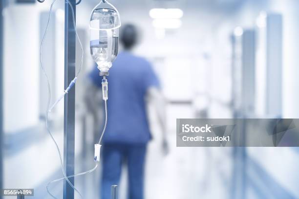 Drip On The Background Of Doctor Walking Down The Hall Stock Photo - Download Image Now