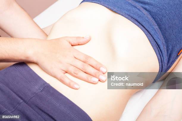Woman Receiving Osteopathic Treatment Of Her Belly Stock Photo - Download Image Now - Abdomen, Physical Therapy, Human Abdomen