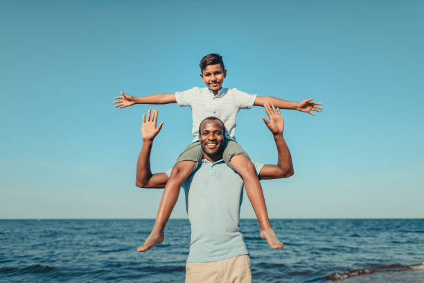 istock happy father carrying son on neck 856547934