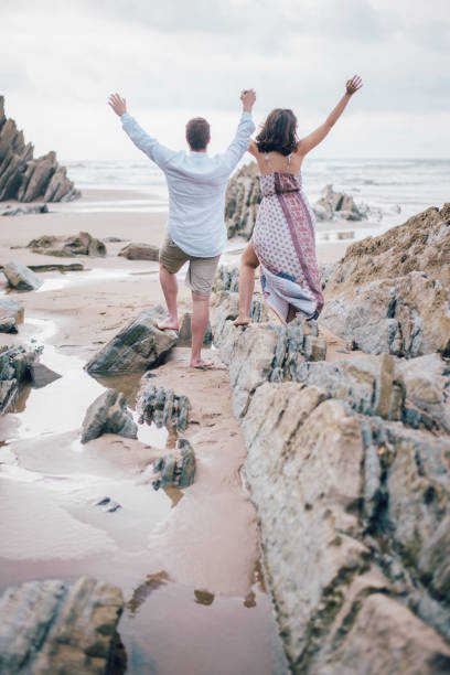 istock Young couple with arms raised 856549504