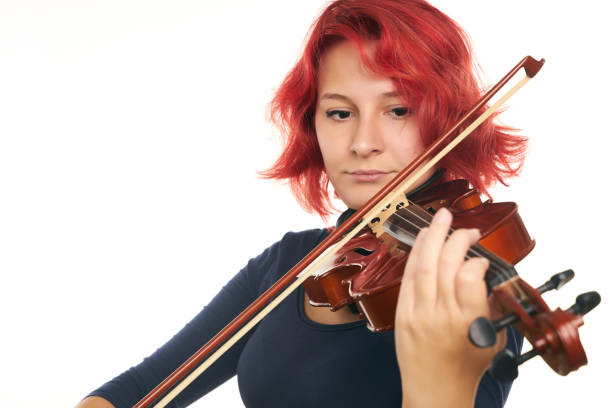 istock Beautiful young redhead woman playing the violin 856552810