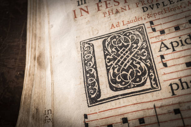 church choir books on a wooden lectern. detail of capital letter, macro, Very old deteriorated books 16th century, vintage