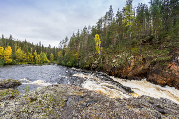 istock Red cliff, stone wall, forest, waterfall and wild river view in autumn. Fall colors - ruska time in Kiutaköngäs. One part of Karhunkierros Trail. Oulanka National Park, north Finland, Lapland, Europe 856557104