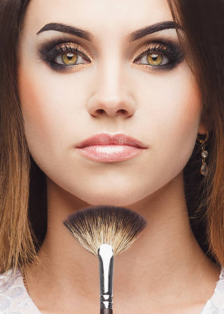 istock Beautiful woman with a brush for makeup in the hand 856559724