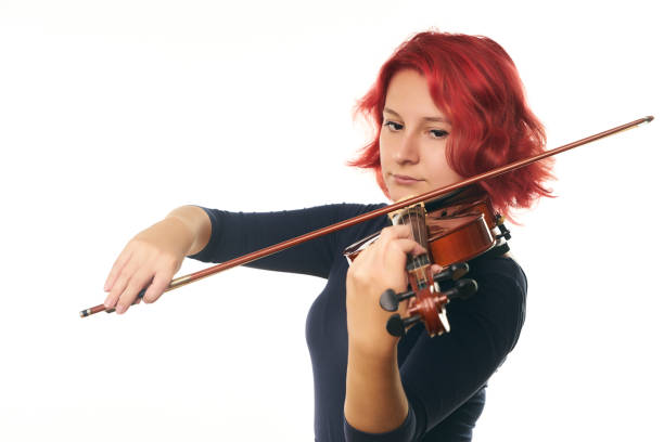 istock Beautiful young woman playing the violin 856559758