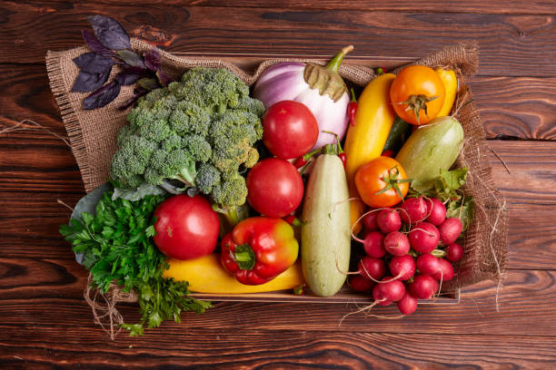 istock Fresh Vegetables in wooden box on brown wooden background. 856559960