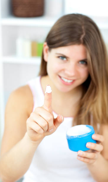 istock Cute woman putting makeup on her face 856560228