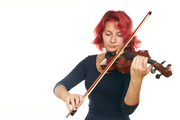 istock Beautiful young redhead woman playing the violin 856561572