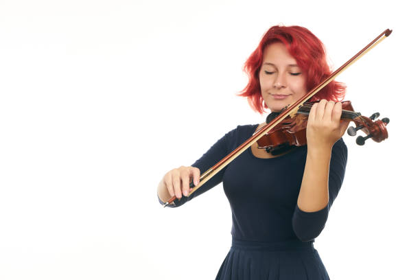 istock Beautiful young redhead woman playing the violin 856561808