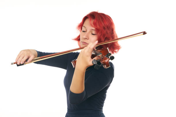 istock Beautiful young redhead woman playing the violin 856562174