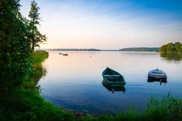 Rowing boats floating over the Lake Elk waters. Masuria, Poland.