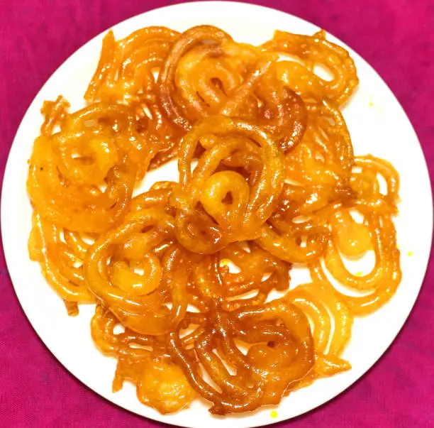 Jalebi, popular Indian sweet dessert made of deep fried dough.