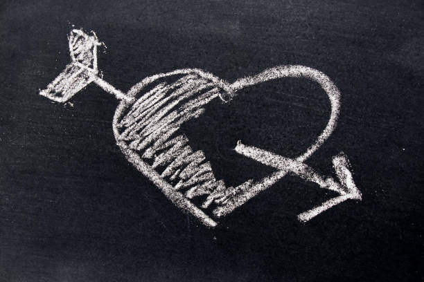 istock White chalk drawing in heart with arrow shape on black board background use for decoration in valentine, love, couple or engagement concept 856568304
