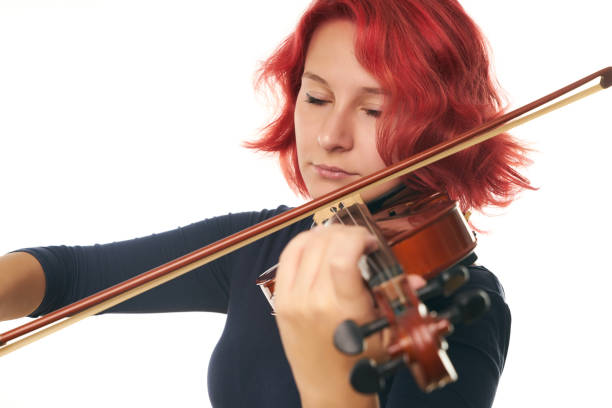 istock Beautiful young woman playing the violin 856568580