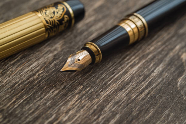 istock Ink pen on a wooden background 856568592