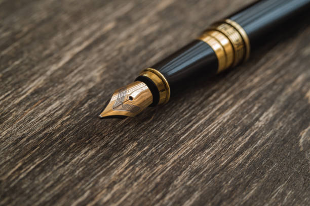 istock Ink pen on a wooden background 856568666