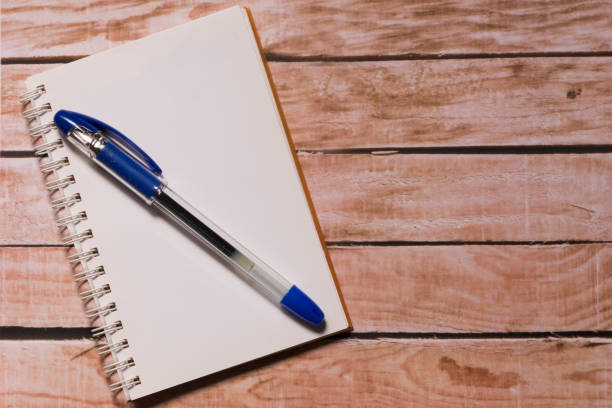 istock Opened notepad on top of a wooden board 856572042