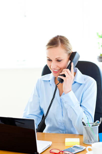 istock Ambitious businesswoman talking on phone using her laptop 856572144