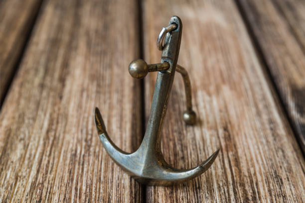 istock Anchor on a wooden background 856575118