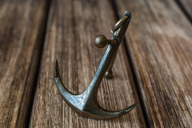 istock Anchor on a wooden background 856575158