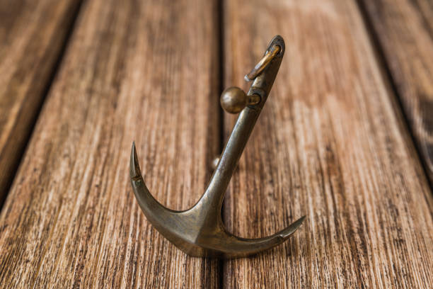 istock Anchor on a wooden background 856575214