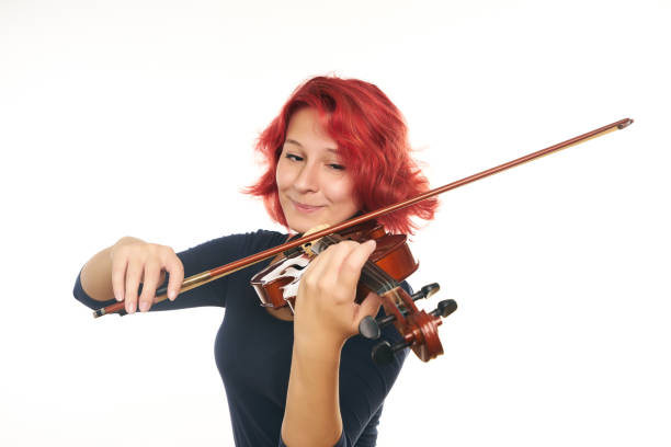 istock Musician young woman playing violin 856579520