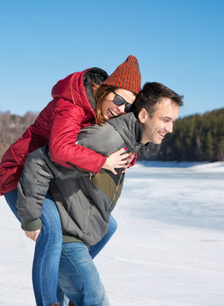 istock Happy couple having fun on a frozen lake 856579614