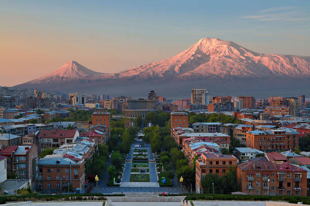 View over the city of Yerevan, capital of Armenia, with the two peaks of the Mount Ararat in the background, at the sunrise. Skyline of Yerevan, capital of Armenia, at the sunrise with Mt Ararat in the backgroud. dormant volcano stock pictures, royalty-free photos & images