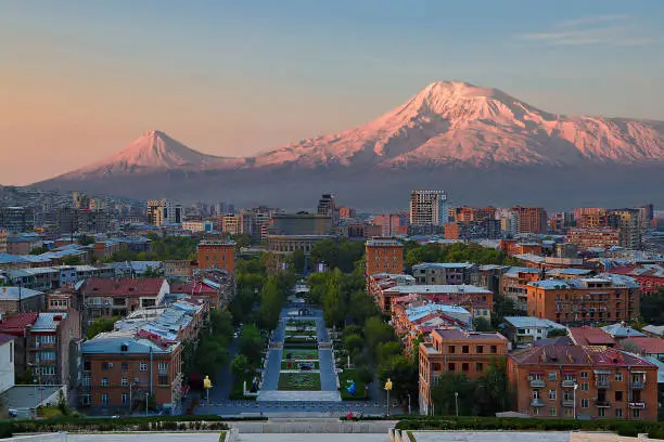 Photo of View over the city of Yerevan, capital of Armenia, with the two peaks of the Mount Ararat in the background, at the sunrise.