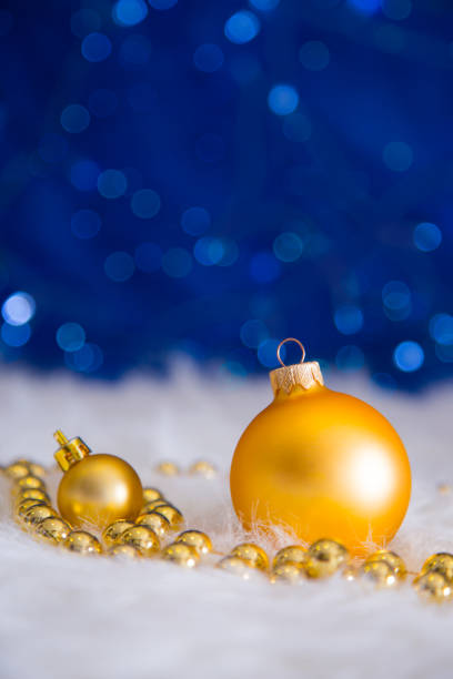 istock Golden Christmas balls and beads on blue bokeh background 856586028