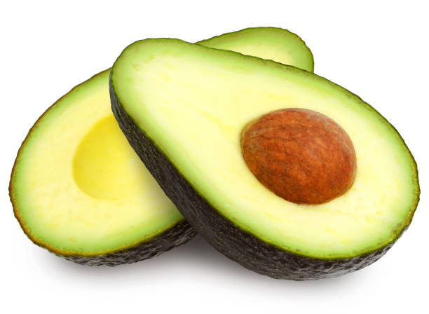 dwa plasterki awokado. - avocado cross section vegetable seed zdjęcia i obrazy z banku zdjęć