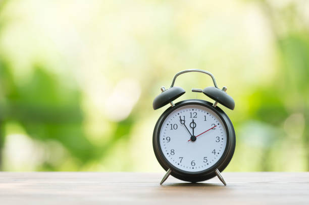 istock Retro alarm clock with five minutes to twelve o'clock. 856589006